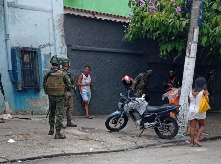 Homem é revistado no Complexo do Lins por agentes da Marinha, que informa estar fazendo reforma de muro.