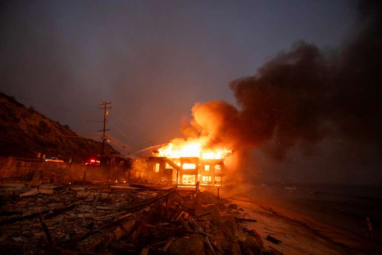 Fogo engole estrutura durante incêndio, em vendaval no Oeste de Los Angeles, Califórnia, Estados Unidos (7/2/2025)