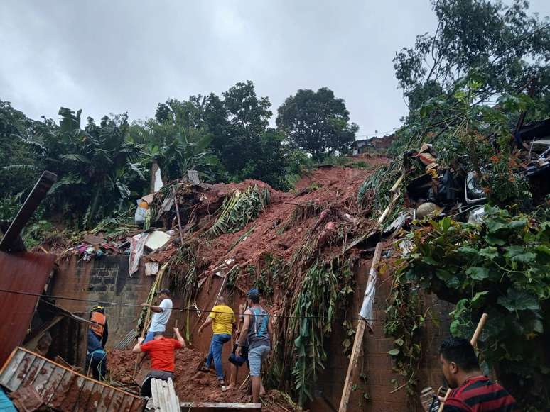 Moradores tentam vencer os escombros, mas os restos só poderão retirados com máquinas.