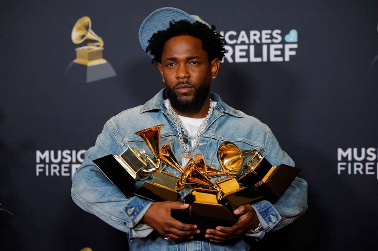 Kendrick Lamar carregando troféus após premiação do Grammy