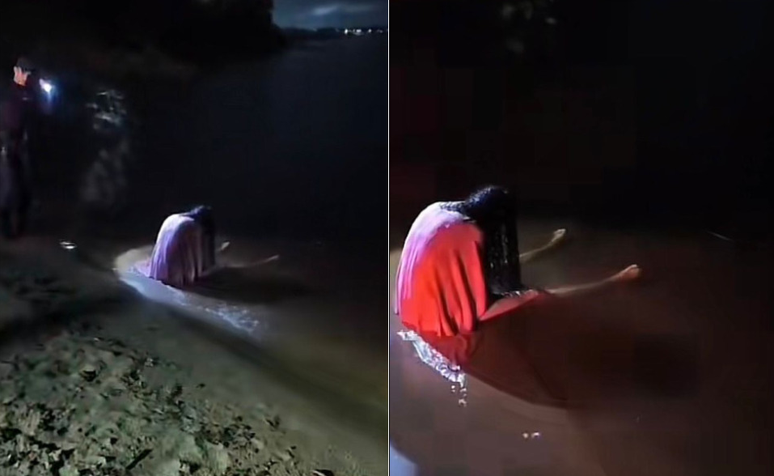 Mulher é vista sentada na orla da Praia da Ponta Negra, em Manaus, na madrugada de 20 de abril