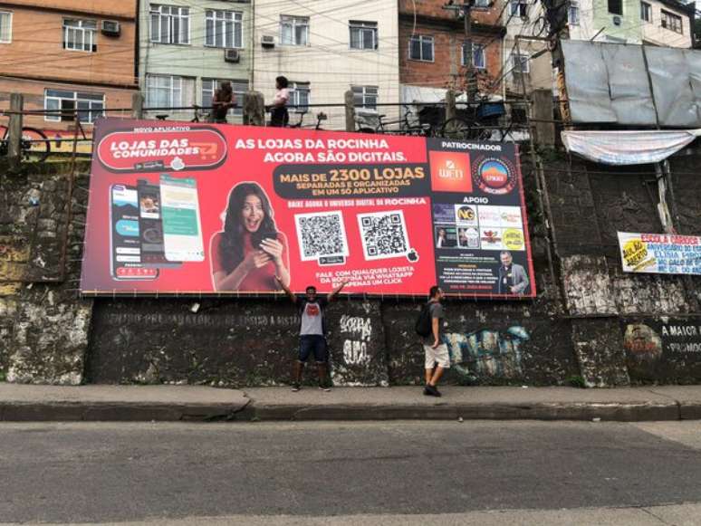 Outdoor de divulgação do aplicativo Lojas das Comunidades. Propaganda do negócio é feita em pontos estratégicos das favelas.