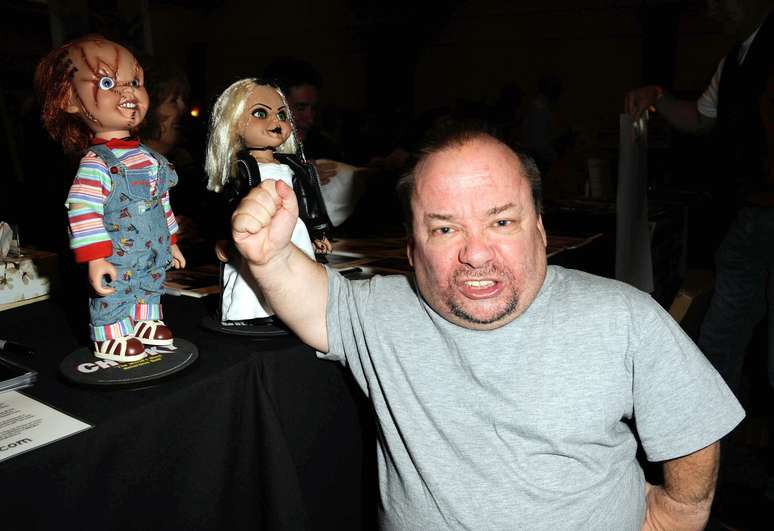 Ed Gale ao lado de uma escultura do Chucky, personagem que ele interpretou em "O Brinquedo Assassino"