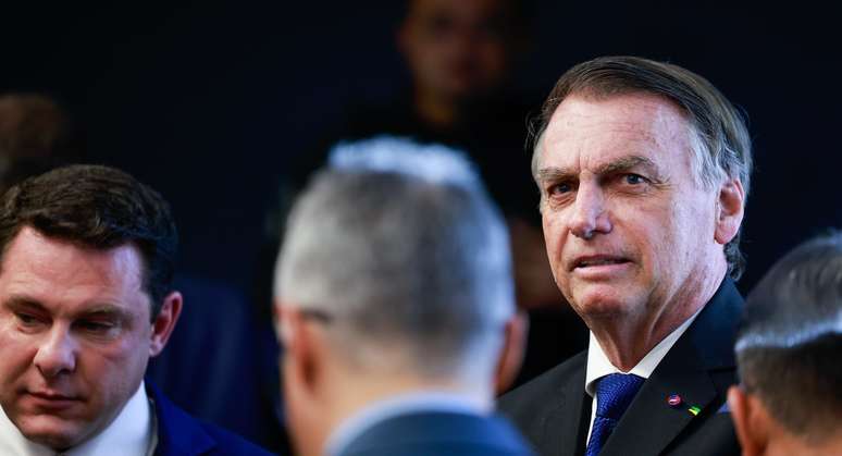 Ex-presidente Jair Bolsonaro com broches pendurados em seu paletó