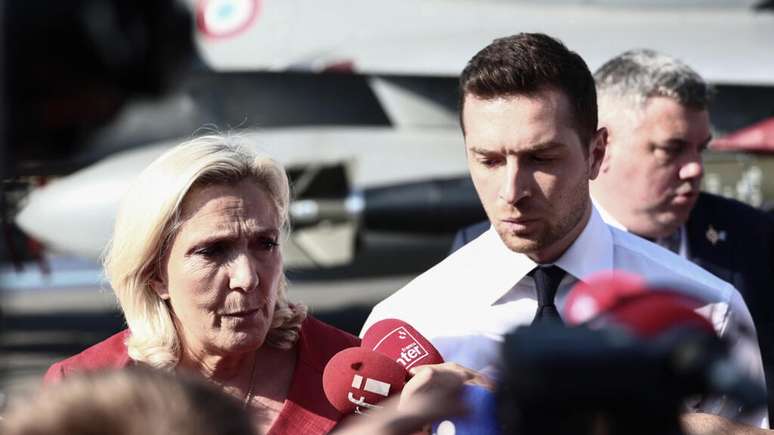 Marine Le Pen (à esquerda) e Jordan Bardella falam com a imprensa durante a 55ª edição do Salão Internacional da Aeronáutica de Paris, em Le Bourget, em 19 de junho de 2025.