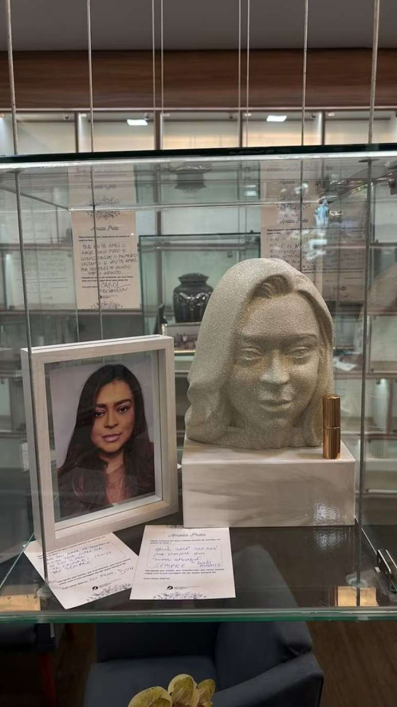 Glass niche with objects left by friends and family, including cards and a lipstick Glass niche with objects left by friends and family, including cards and a lipstick