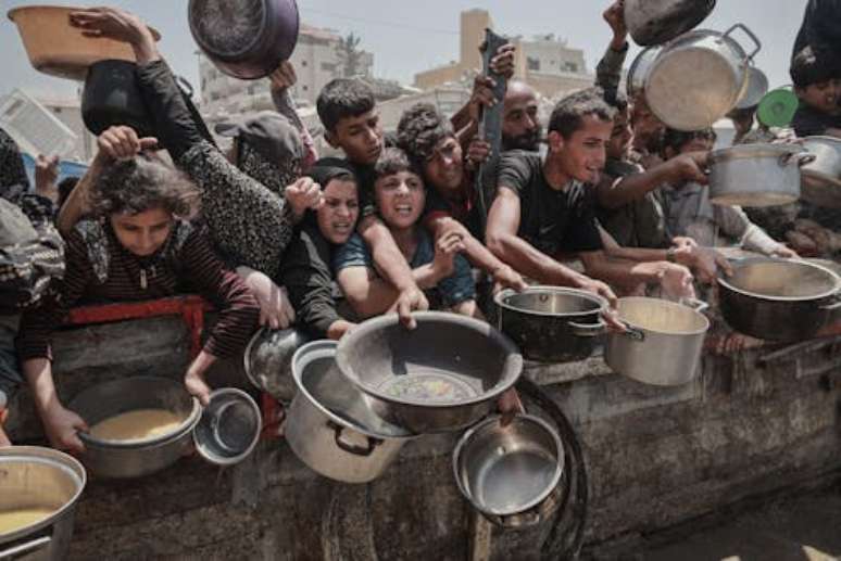Palestinians crowd to get food in Gaza City on July 30, 2025. Abdalhkem Abu Riash/Anadolu via Getty Images