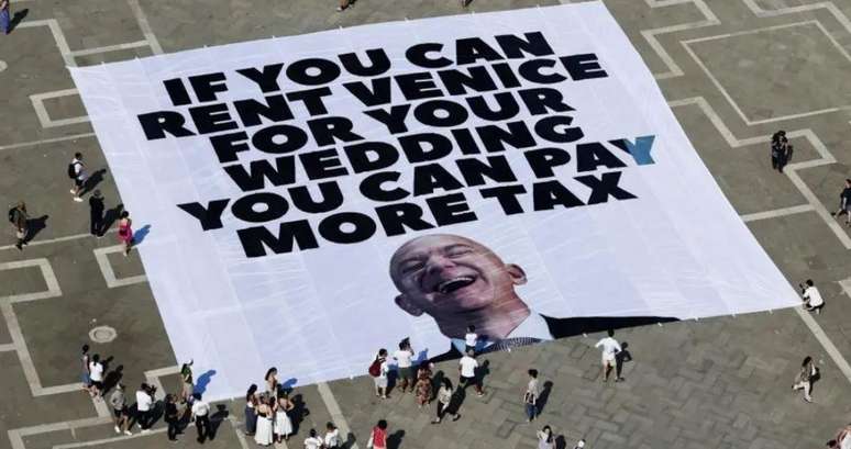Protesters in Venice with poster directed to Jeff Bezos in June, saying 