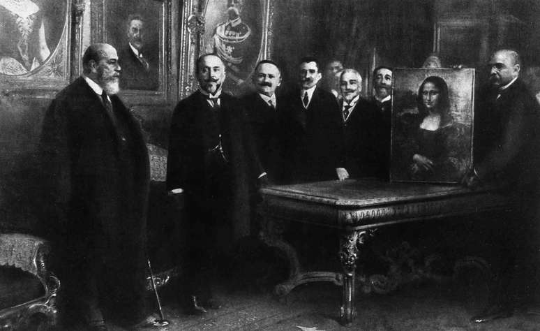 Men in front of the Mona Lisa.