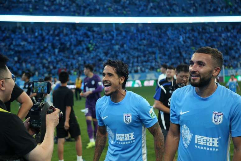 Daniel Benha celebrates wearing a Dalian Yingbo shirt from China