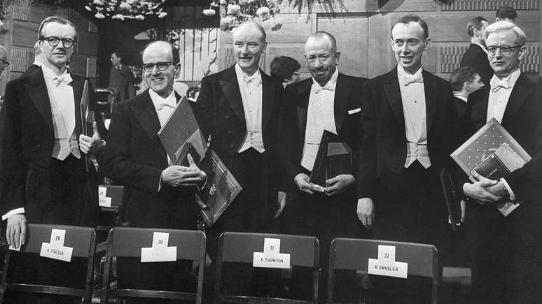 Ganhadores do Pr&ecirc;mio Nobel em 1962. Da esquerda para a direita, Maurice H. Wilkins (Medicina, 1916-2004); Max Perutz (Qu&iacute;mica, 1914-2002); Francis Crick (Medicina, 1916-2004); John Steinbeck (Literatura, 1902-1968); James D. Watson (Medicina, 1928-2025); e John Kendrew (Qu&iacute;mica, 1917-1997).