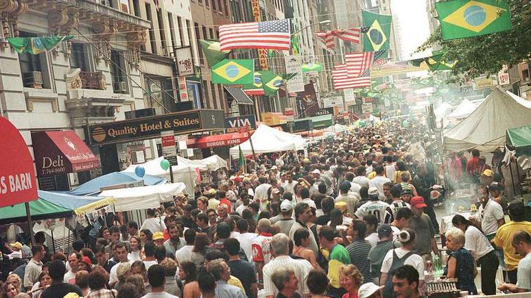 Thousands of people walk along 46th Street in New York during the Brazil Day Street Festival on September 5, 1999