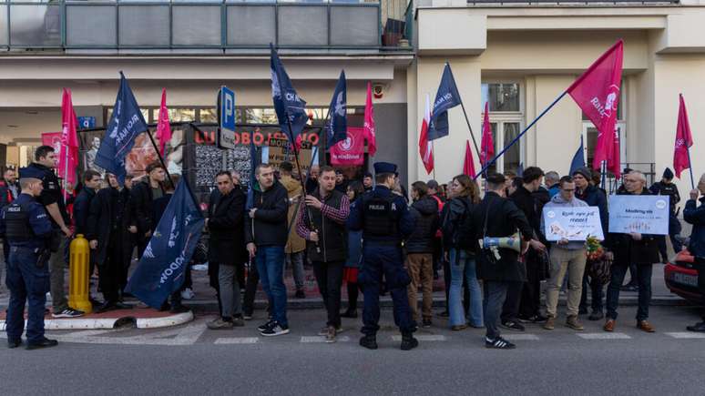 Anti-abortion activists block the entrance to the first activist-run abortion counseling point in Poland, one day after the site opened in Warsaw on March 8, 2025.