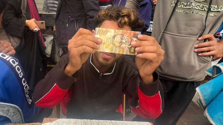 Baraa Abu Aoun repairs banknotes in Gaza