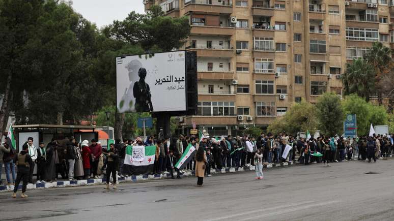 Syrians gather on the day of a military parade to mark the first anniversary of the fall of Bashar al-Assad, in Damascus, Syria, December 8, 2025.
