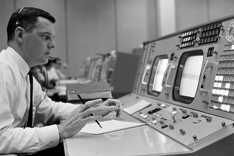 Glynn Lunney, futuro supervisor do programa de &ocirc;nibus espaciais da Nasa, no seu console do centro de controle de miss&otilde;es da Nasa
