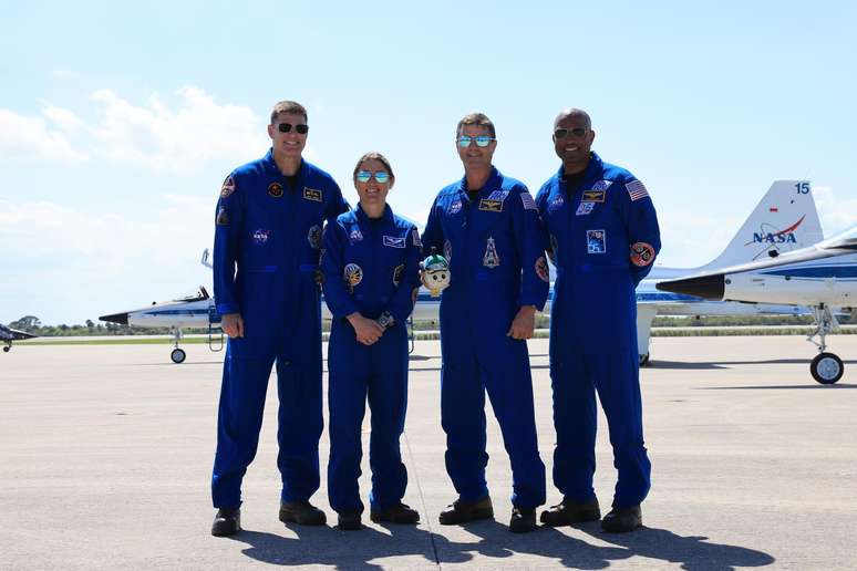 Da esquerda para a direita, o especialista da miss&atilde;o Artemis II, Jeremy Hansen, da CSA (Ag&ecirc;ncia Espacial Canadense), a especialista da miss&atilde;o Christina Koch, o comandante Reid Wiseman e o piloto Victor Glover chegam na sexta-feira, 27 de mar&ccedil;o de 2026, &agrave;s instala&ccedil;&otilde;es de lan&ccedil;amento e pouso do Centro Espacial Kennedy da NASA, na Fl&oacute;rida, em prepara&ccedil;&atilde;o para o voo de teste da Artemis II. A miss&atilde;o Artemis II levar&aacute; a tripula&ccedil;&atilde;o em uma jornada de 10 dias ao redor da Lua e de volta a bordo do foguete SLS (Sistema de Lan&ccedil;amento Espacial) e da espa&ccedil;onave Orion da NASA, a partir do Complexo de Lan&ccedil;amento 39B, n&atilde;o antes das 18h24 (hor&aacute;rio de Bras&iacute;lia) da quarta-feira, 1&ordm; de abril.