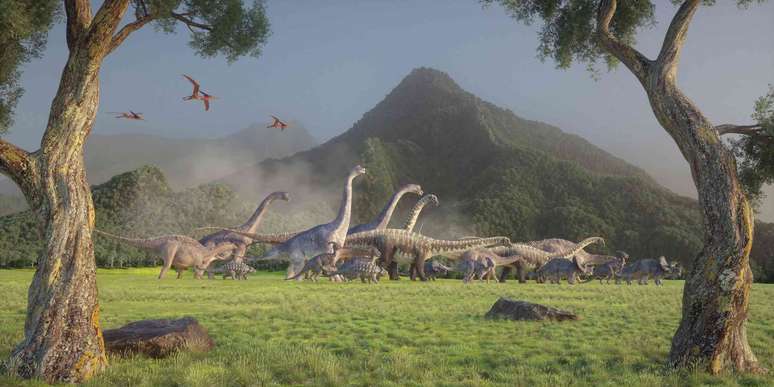 Ilustra&ccedil;&atilde;o de dinossauros caminhando em um vale.