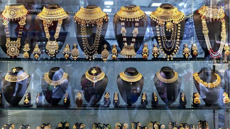 Duas fileiras de elaborados colares de ouro, expostos em uma joalheria