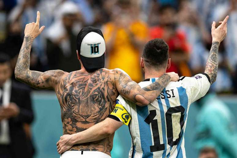 Uma grande tatuagem de tigre &eacute; vis&iacute;vel nas costas nuas de um jogador de futebol, enquanto a tatuagem no bra&ccedil;o de outro jogador pode ser vista quando eles levantam a m&atilde;o direita ap&oacute;s uma vit&oacute;ria.