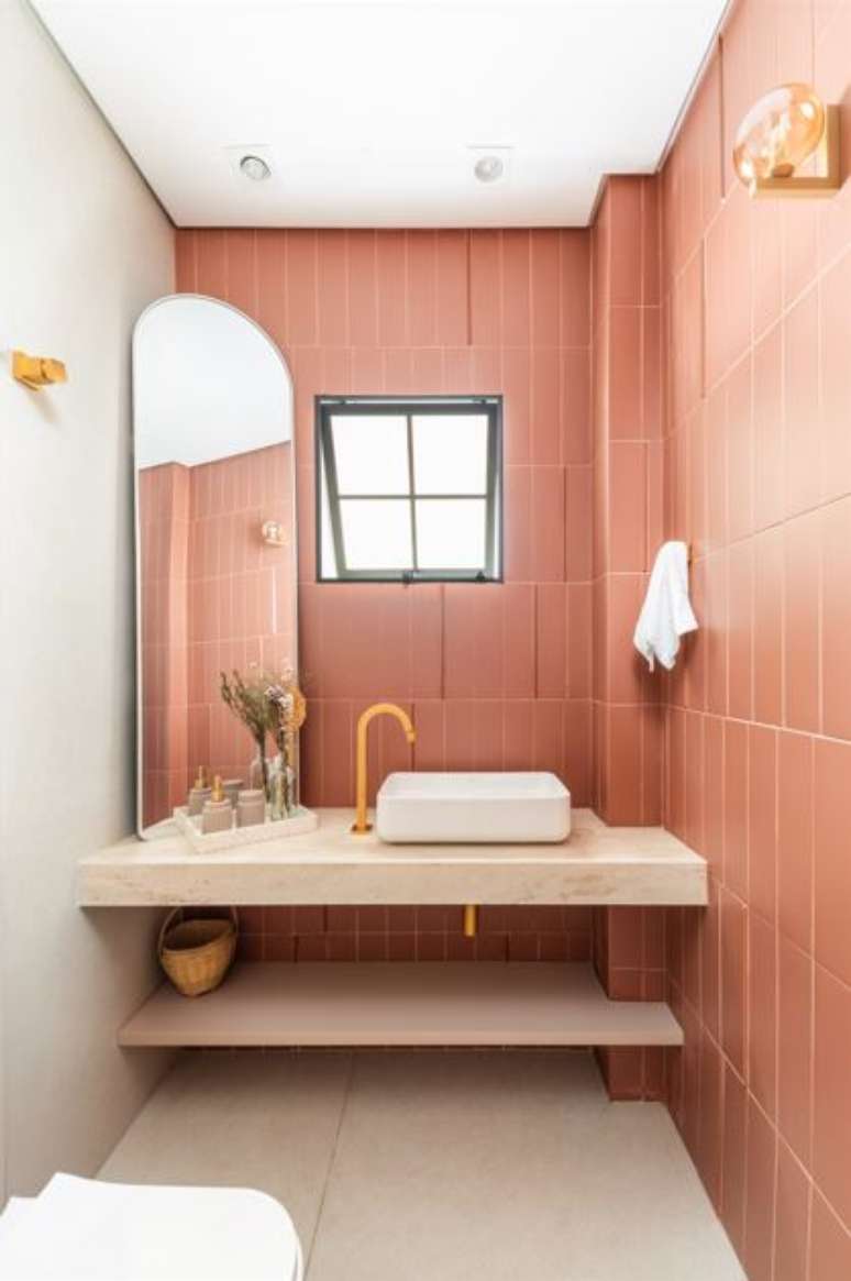 Entre os ambientes da resid&ecirc;ncia, o lavabo se destaca pelo revestimento Terralma e a bancada em travertino acrescenta textura natural e equil&iacute;brio ao conjunto. Projeto BMA Studio&nbsp;|