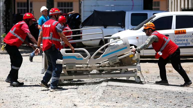 Equipes de resgate transportam uma maca do lado de fora do Hospital Universit&aacute;rio del Valle
