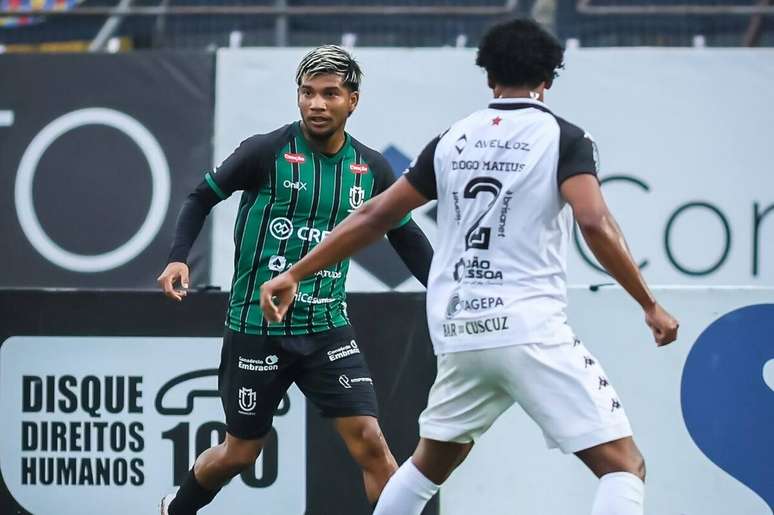 Negueba (de verde) leva o Maring&aacute; ao ataque e &eacute; marcado por Diogo Mateus.