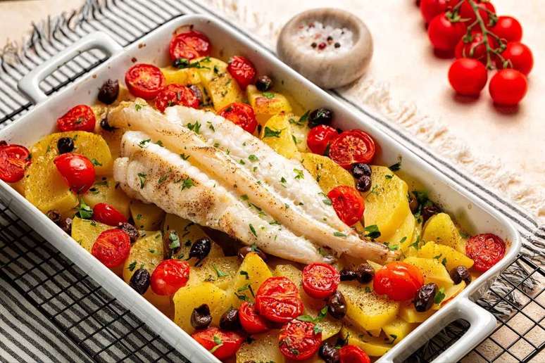 Peixe assado com batatas, tomate-cereja e azeitonas 