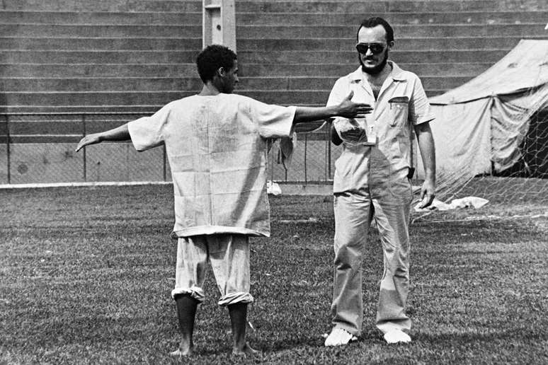 Profissional t&eacute;cnico avalia o n&iacute;vel de radia&ccedil;&atilde;o de um homem em um hospital provis&oacute;rio, instalado em um est&aacute;dio de futebol