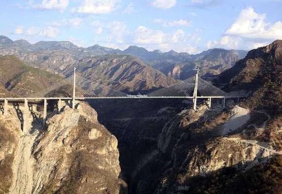 A general view of the Baluarte Bridge, the highest suspension bridge in the world, that connects the north-western state of Sinaloa with Durango and Mazatlan, January 5, 2012. At 1,124 metres long (3,687 feet) and hanging at over 400 metres high (1312 feet), the Baluarte Bridge is part of the country's elaborate bicentennial celebrations to mark its independence from Spain in 1810. REUTERS/Alfredo Guerrero/Mexico Presidency/Handout (MEXICO - Tags: BUSINESS CONSTRUCTION) FOR EDITORIAL USE ONLY. NOT FOR SALE FOR MARKETING OR ADVERTISING CAMPAIGNS. THIS IMAGE HAS BEEN SUPPLIED BY A THIRD PARTY. IT IS DISTRIBUTED, EXACTLY AS RECEIVED BY REUTERS, AS A SERVICE TO CLIENTS
