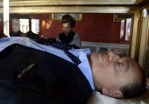 Silvio Berlusconi yace muerto en una vitrina dentro del Palazzo Ferraioli, edificio ubicado justo enfrente del Palazzo Chigi, sede del Gobierno italiano, donde el ex mandatario movió los hilos de su país durante 17 años.