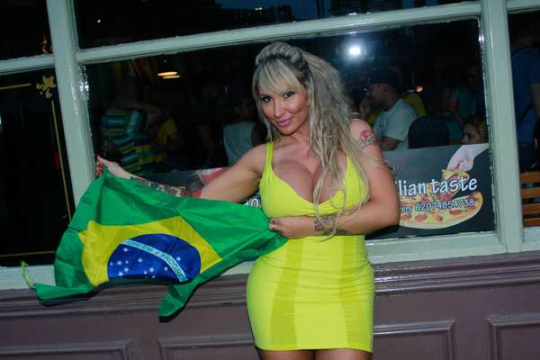 Mesmo em Londres, na Inglaterra, a DJ Sabrina Boing Boing comemorou a vitória do Brasil sobre o Uruguai por 2 a 0, nesta quarta-feira (26), pela Copa das Confederações. Com um decote generoso, a loira saiu pela cidade europeia exibindo uma bandeira do Brasil
