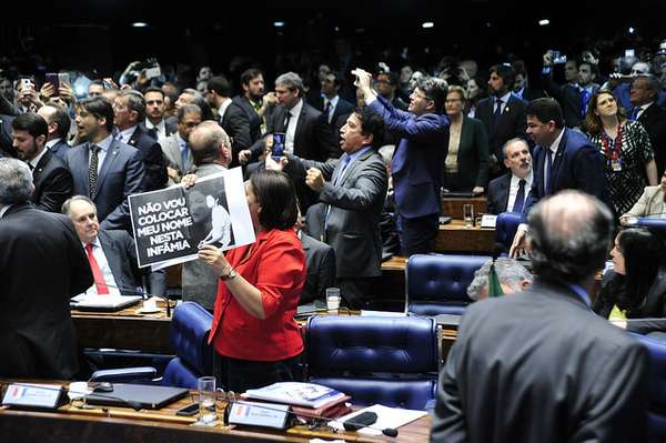 Senadores celebram e tiram fotos com seus celulares do placar no momento em que a votação pela cassação de Dilma Rousseff teve resultado anunciad