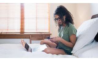 Working woman sitting on the bed Working woman sitting on the bed