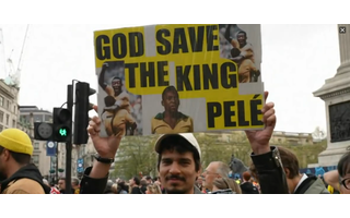 A Brazilian protester carried a banner saluting Pele