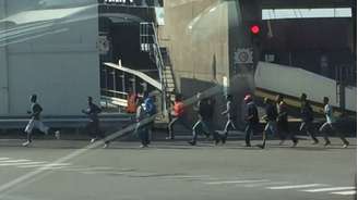 <p>Imigrantes são vistos correndo após tentar invadir a balsa</p>