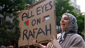 Uma manifestante pró-Palestina segura um cartaz com os dizeres “Todos os olhos voltados para Rafah” em frente à Universidade Sorbonne, em Paris, na França