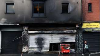 Supermercado e apartamentos ficam destruídos após tumultos em Belfast, na Irlanda do Norte, desencadeados por ataque com faca.