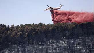 Um avião Dash 8-Q400MR lança um produto para conter o avanço de um incêndio florestal em Taradeau, no departamento de Var, em 20 de julho de 2026.