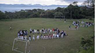 Participantes da assembleia de jovens indígenas se reúnem em campo de futebol, na reserva de Las Delicias, em Cauca, região afetada pelo conflito.