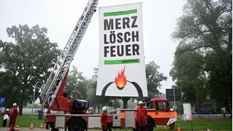 Ativistas do Greenpeace protestam contra o governo alemão: "Merz, acabe com o fogo".