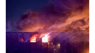 A fumaça do incêndio sobe acima da sala de concertos Crocus City Hall em chamas após um tiroteio, nos arredores de Moscou