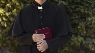 Padre com bíblia na mão