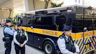 Policiais vigiaram o camburão transportando Jimmy Lai, após o julgamento do ex-magnata da mídia por ameaça à segurança nacional em Hong Kong, nesta segunda-feira 15 de dezembro de 2025.