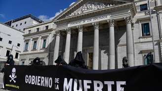 Manifestantes vestidos representando a morte protestam contra a lei que legaliza a eutanásia, em Madri, em março de 2021