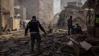 Um homem passa diante dos escombros de um prédio no local de um ataque israelense no Líbano, em 8 de abril de 2026.