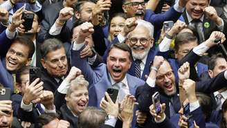 O senador Flávio Bolsonaro (ao centro) comemora no Congresso Nacional a derrubada do veto do presidente Lula ao PL da Dosimetria que reduz as penas dos condenadas pela tentativa de golpe de Estado e pelos atos de 8 de janeiro de 2023, em Brasília, em 30 de abril de 2026.