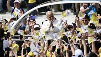 O papa Leão XIV cumprimenta a multidão do papamóvel na Piazza Nicola Calipari durante uma visita pastoral à comunidade da “Terra dei Fuochi”, em 23 de maio de 2026. A Terra dei Fuochi é uma área da região sul italiana da Campânia onde, sistematicamente desde o fim dos anos 1980, resíduos tóxicos foram despejados pelo crime organizado (Camorra), provocando crimes ambientais ligados ao lixo.