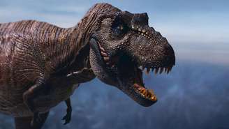 Imagem ilustrativa mostra a parte frontal de um dinossauro T. rex com uma mandíbula grande e aberta e braços pequenos.