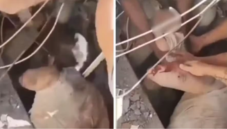 Mãe e filho são retirados de escombros